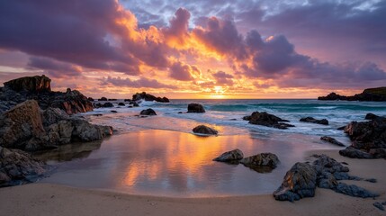 Fiery sunset kisses rocky shoreline