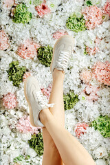 Beautiful female legs in sneakers. Place under text. shoe advertising. Girl in sneakers