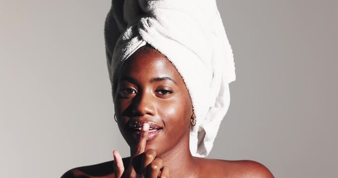 Black woman, face and sugar scrub on lips for beauty treatment, skincare or natural exfoliation. Portrait, mouth and model apply facial cosmetics for glow, peeling or clean on white studio background