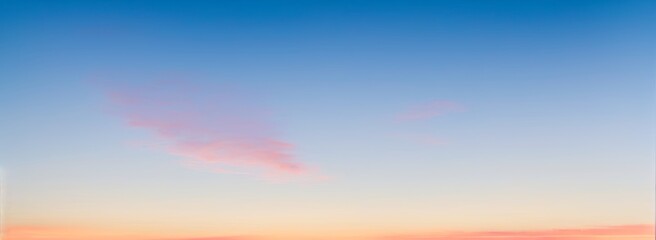 Sky with pink clouds fading into orange and blue gradient at sunset. luxury premium real sunset and sunrise photo collection for background