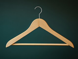 Minimalist Composition of Wooden Clothes Hanger on Teal Background