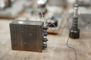 Vintage electronic device on wooden table in workshop showcasing intricate design and components...