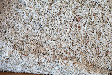 Close-up of a pile of tiny, dried ikan teri (Indonesian small anchovies). Salty and umami-rich ingredient.