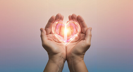 Hands holding glowing heart symbol with romantic atmosphere and copy space for text