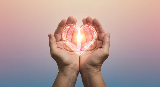 Hands holding glowing heart symbol with romantic atmosphere and copy space for text