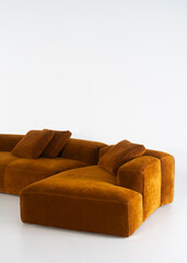 Luxurious brown velvet sectional sofa with throw pillows on white backdrop – Isolated on White...