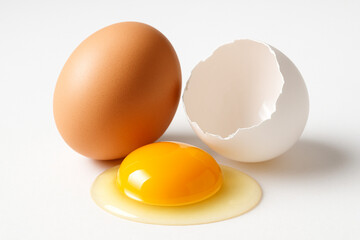 Broken Brown Egg with Yolk on White Background