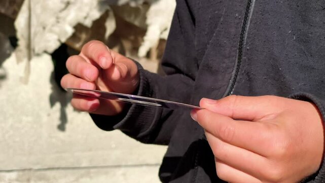 A person holding a white disc in their hands