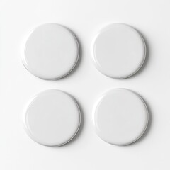 Four blank, round, white buttons