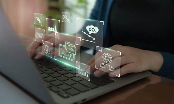 Carbon Data Open Protocol (CDOP) concept. Using a laptop and digital icons representing CO2 tracking, environmental data integration and transparent carbon management through open data protocols.