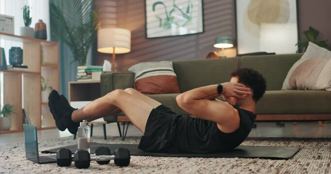 Home, crunches and man with fitness, exercise and training routine with endurance, wellness and laptop. Apartment, healthy person and athlete in lounge, energy and workout with core strengthening