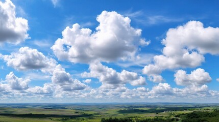 Puffy Clouds Over Rural Landscape Beneath a Clear Blue Sky