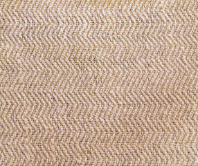 Texture of natural beige linen fabric with zigzag weave pattern background