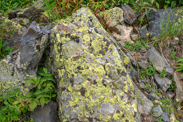 The surface of the rock. The surface of natural hard stone. Rocks in the mountains. Rocks, minerals, and minerals.