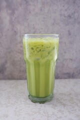 Iced milk green tea front view food table	