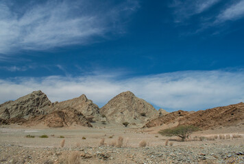 Oman, Middle East, 03-08-2025: driving on the roads of the Sultanate of Oman, panoramic view of mountains and desert landscape on the road between Muscat and Nizwa crossing remote villages