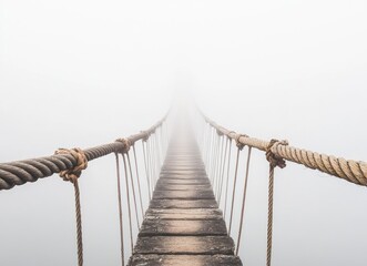 Obraz premium Mystical Rope Bridge Suspended in Fog, Ethereal Pathway to Unknown Destination, Surreal Adventure Concept, Misty Sky Background