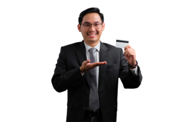 Confident young Asian businessman holding credit card and smiling isolated on transparent background