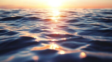 Golden sunset over rippling ocean surface.