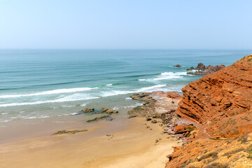 Picturesque red cliffs on shores of the Atlantic Ocean. Morocco