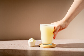 Protein shake and protein powder in a scoop, collagen, creatin, food supplement