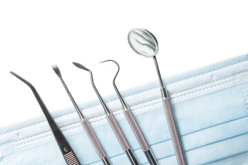 Dental tools set for dentistry inspection and face mask.