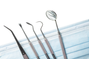 Dental tools set for dentistry inspection and face mask.