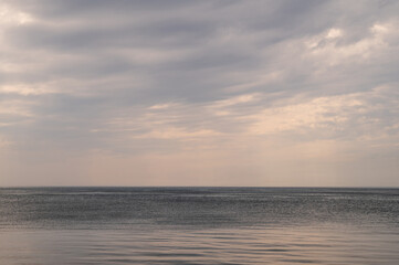 Fototapeta premium Ocean with sky in horizon. Calm sea in evening. Seascape at sunset.