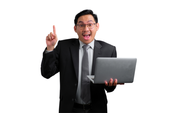 Excited young Asian businessman pointing up while holding laptop isolated on transparent background