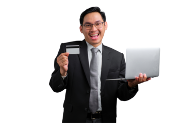 Happy young Asian businessman holding credit card and laptop while smiling isolated on transparent background