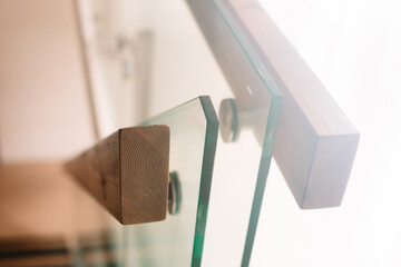 Selective focus to wooden railings mounted to glass.