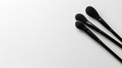 A chic and modern makeup brush set with matte black handles, perfectly positioned on a white background,