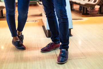 Fototapeta premium Couple wearing bowling shoes getting ready to play bowling