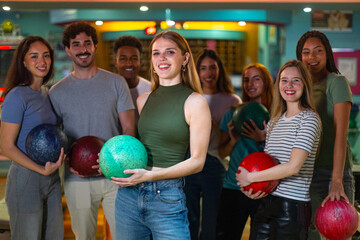 Group of friends enjoying bowling together at alley