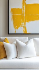 Modern living room with bright yellow abstract art and cozy white pillows in a stylish interior design