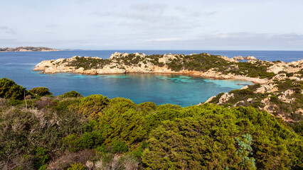 Cala Napoletana's secluded bay, Caprera Island, Italy. Turquoise water, lush vegetation, and...