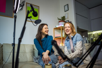 Fototapeta premium Creative teamwork: women recording a podcast in a cozy home setting.