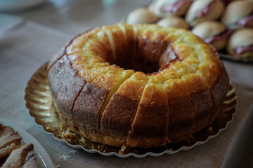 detail of a table set with a ring cake cut into slices ready to be served at the buffet