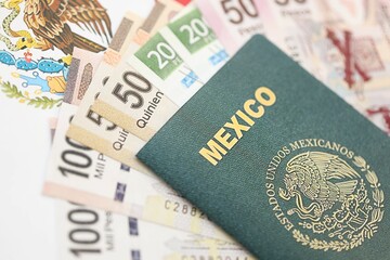 Obraz premium Mexican pesos money bills in big amount and passport lies on Mexico flag close up