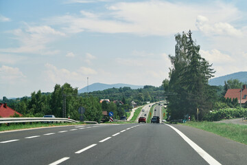 Vehicles moving on road with mountain view
