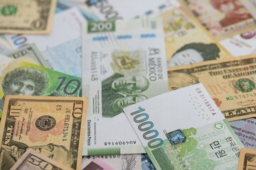 Big amount of money bills of different currencies and countries. Assortment background of international cash in big pile close up