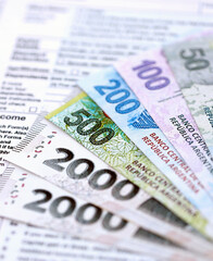 Argentine pesos money bills in big amount lies on table with pen and tax forms close up