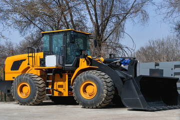 A large excavator stands in a parking lot