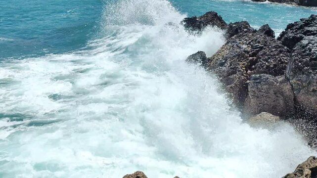 slow otion big waves that hit the coral rocks very hard and powerfully