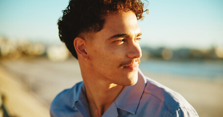 Sunset, thinking and beach with man, vacation and nature with memory, reflection and wonder. Seaside, summer holiday and happy person with weekend break, decision and choice with peace or travelling