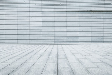 Empty perspective view of grey square floor pavement leading to a modern architecture building...