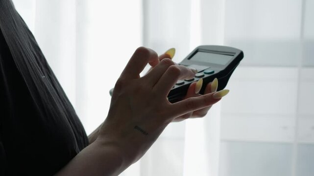 An employee of a financial company calculates finances on a calculator.
A financier works out a strategy for earning money for the year.
An annual budget for a bank.
A businesswoman makes calculations