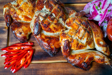 Grilled chicken served with fresh vegetables and spicy peppers
