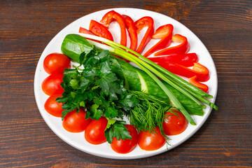 Fresh vegetables arranged artfully on a white plate