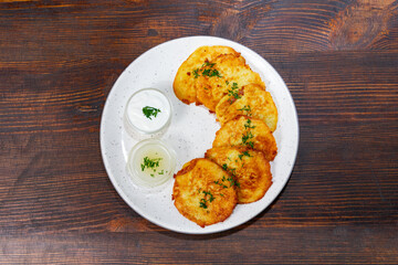 Delicious savory pancakes served with dipping sauces on a plate
